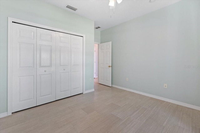 unfurnished bedroom featuring a closet, visible vents, and baseboards