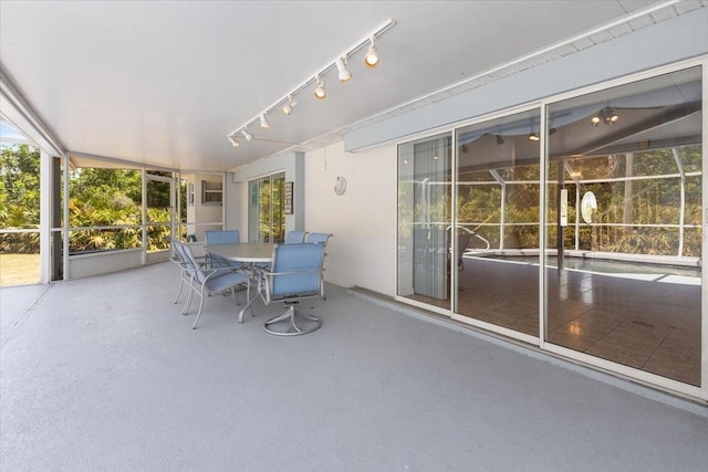 unfurnished sunroom featuring outdoor dining space