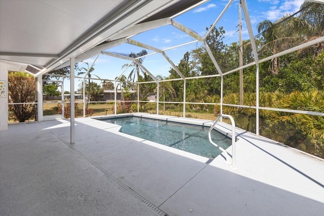 pool with a patio area and glass enclosure