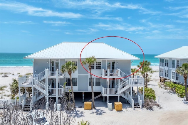 7554 Palm Island Dr S Unit 1822, Placida, FL 33946 - back of property with a water view, stairs, metal roof, and a view of the beach