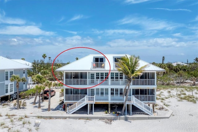 7554 Palm Island Dr S Unit 1822, Placida, FL 33946 - back of house with a balcony, stairs, and a sunroom