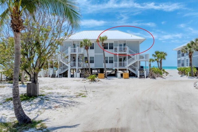 7554 Palm Island Dr S Unit 1822, Placida, FL 33946 - view of front of house with a water view, stairway, a porch, and a beach view