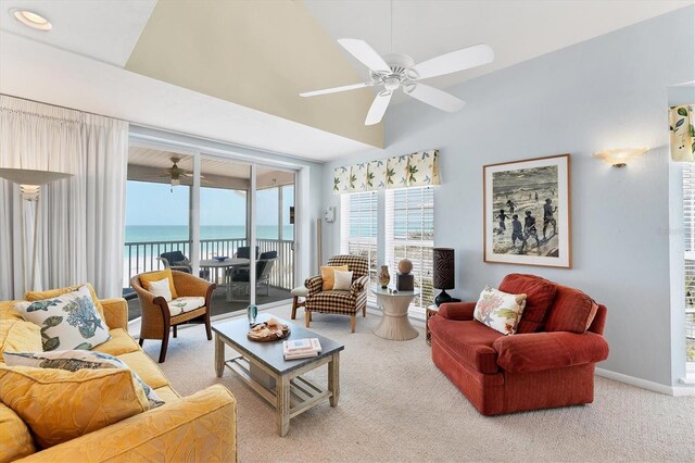 7554 Palm Island Dr S Unit 1822, Placida, FL 33946 - living room with vaulted ceiling, ceiling fan, light carpet, a water view, and baseboards