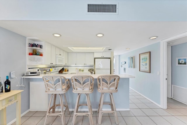 7554 Palm Island Dr S Unit 1822, Placida, FL 33946 - kitchen with a peninsula, open shelves, visible vents, white appliances, and light countertops