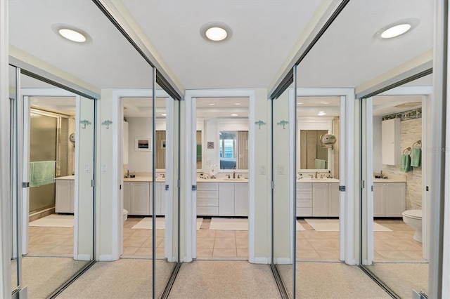 7554 Palm Island Dr S Unit 1822, Placida, FL 33946 - corridor featuring light tile patterned floors and a sink