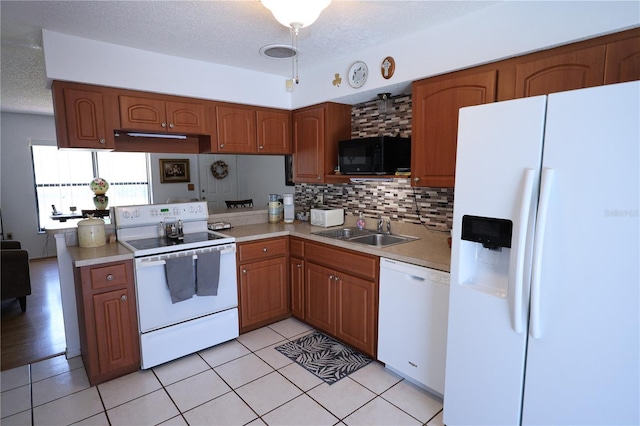 kitchen with white appliances, light countertops, backsplash, a sink, and a textured ceiling