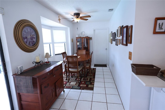 dining room featuring light tile patterned floors, a ceiling fan, and visible vents