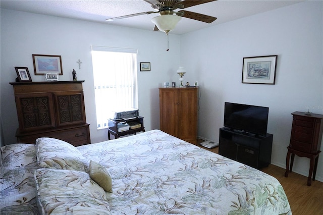 bedroom featuring wood finished floors and ceiling fan