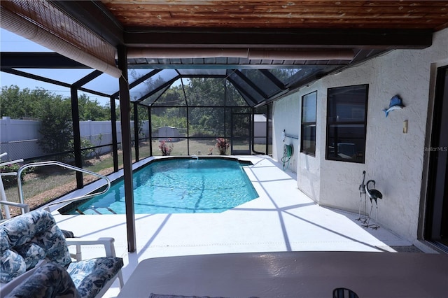 view of swimming pool with a patio, a fenced in pool, glass enclosure, and a fenced backyard