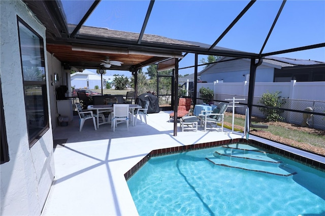 view of pool with a patio, fence, a ceiling fan, and a lanai