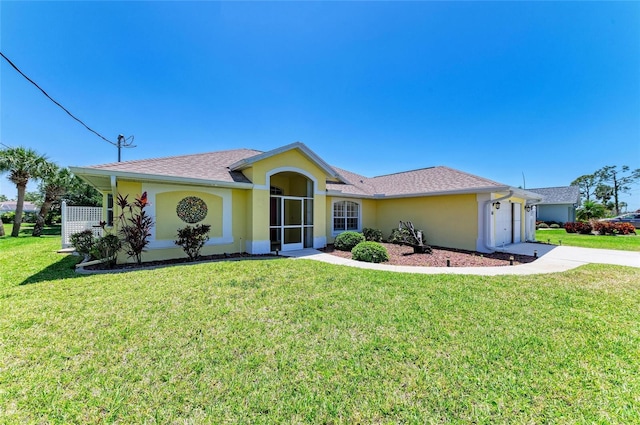 68 Long Meadow Ln, Rotonda West, FL 33947 - view of front of home with a garage, driveway, a front yard, and stucco siding