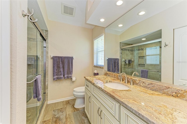 68 Long Meadow Ln, Rotonda West, FL 33947 - bathroom featuring a shower stall, visible vents, toilet, vanity, and baseboards