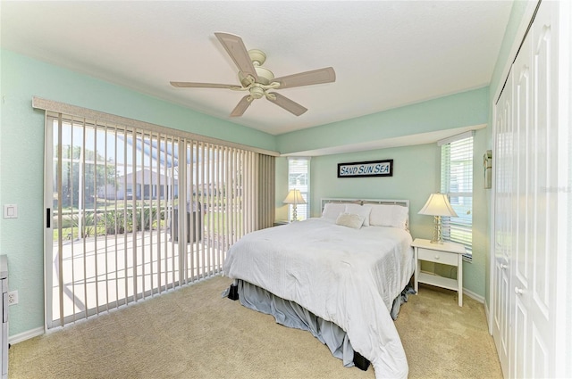 68 Long Meadow Ln, Rotonda West, FL 33947 - carpeted bedroom with a ceiling fan, access to outside, baseboards, and multiple windows