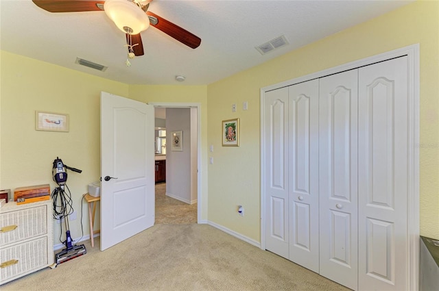 68 Long Meadow Ln, Rotonda West, FL 33947 - bedroom featuring light colored carpet, a ceiling fan, visible vents, and a closet