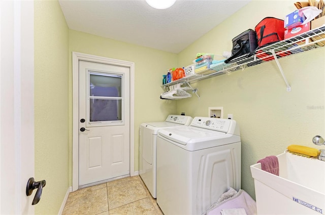 68 Long Meadow Ln, Rotonda West, FL 33947 - laundry room featuring washing machine and clothes dryer, a textured ceiling, a sink, baseboards, and laundry area