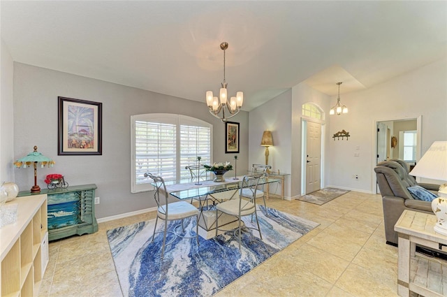 68 Long Meadow Ln, Rotonda West, FL 33947 - tiled dining room with vaulted ceiling, baseboards, and a notable chandelier