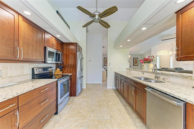68 Long Meadow Ln, Rotonda West, FL 33947 - kitchen with stainless steel appliances, a sink, tasteful backsplash, ceiling fan, and light stone countertops