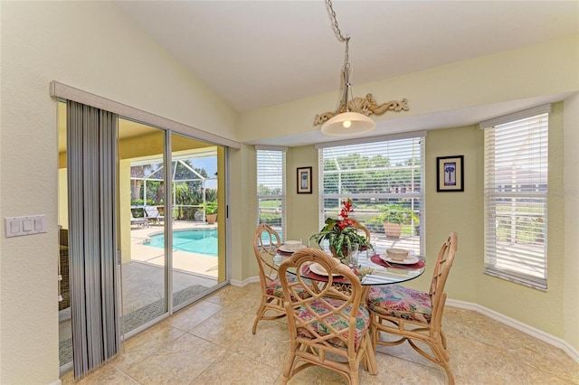68 Long Meadow Ln, Rotonda West, FL 33947 - dining space featuring vaulted ceiling, light tile patterned flooring, and a healthy amount of sunlight
