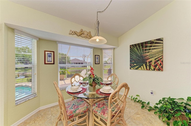 68 Long Meadow Ln, Rotonda West, FL 33947 - dining area featuring lofted ceiling and baseboards