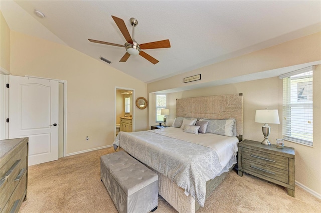 68 Long Meadow Ln, Rotonda West, FL 33947 - bedroom with vaulted ceiling, connected bathroom, light colored carpet, baseboards, and visible vents