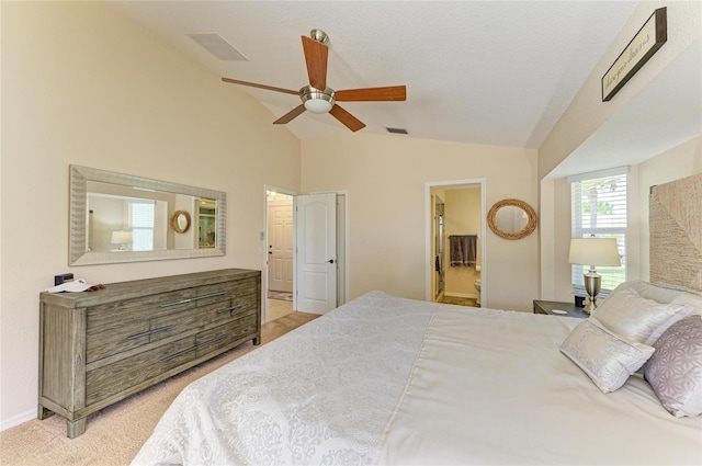 68 Long Meadow Ln, Rotonda West, FL 33947 - bedroom featuring light colored carpet, lofted ceiling, connected bathroom, and visible vents