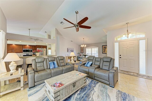 68 Long Meadow Ln, Rotonda West, FL 33947 - living room featuring light tile patterned flooring, vaulted ceiling, visible vents, and ceiling fan with notable chandelier