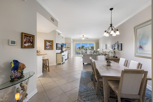 8500 Amberjack Cir Unit 102, Englewood, FL 34224 - dining room featuring crown molding, ceiling fan with notable chandelier, light tile patterned floors, baseboards, and visible vents