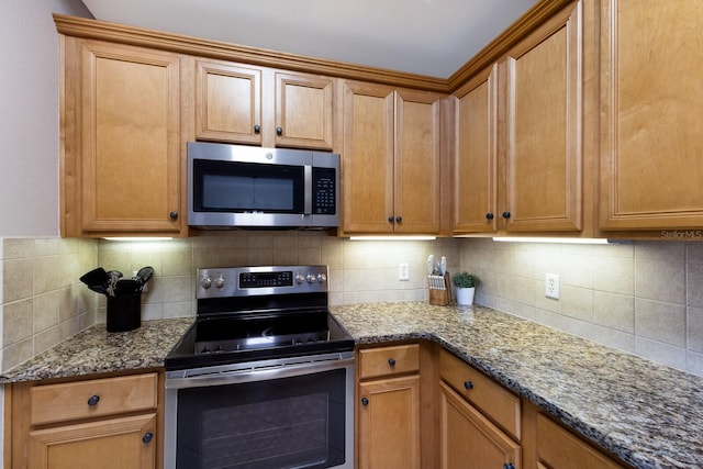 8500 Amberjack Cir Unit 102, Englewood, FL 34224 - kitchen with backsplash, stone counters, and stainless steel appliances