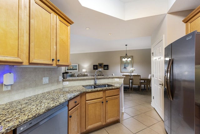 8500 Amberjack Cir Unit 102, Englewood, FL 34224 - kitchen featuring a peninsula, a sink, freestanding refrigerator, an inviting chandelier, and dishwasher