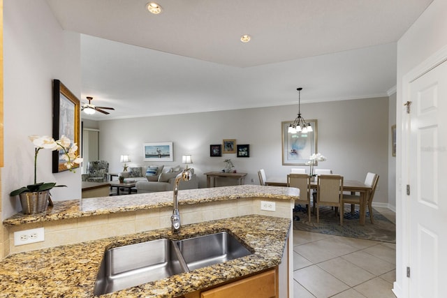 8500 Amberjack Cir Unit 102, Englewood, FL 34224 - kitchen with light stone counters, a sink, light tile patterned flooring, hanging light fixtures, and open floor plan