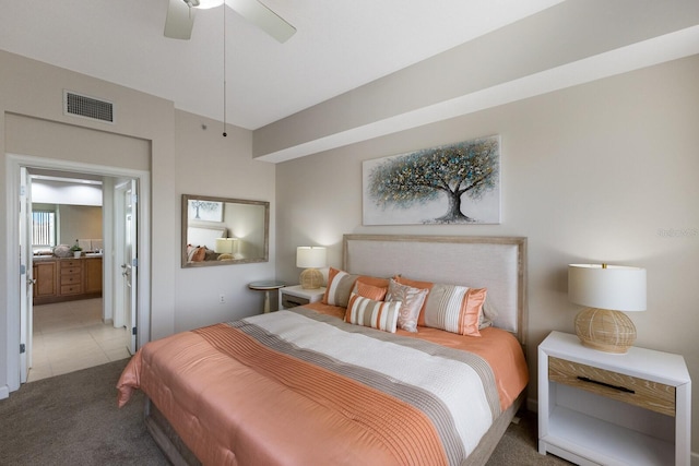 8500 Amberjack Cir Unit 102, Englewood, FL 34224 - bedroom with light carpet, light tile patterned flooring, visible vents, ceiling fan, and ensuite bath