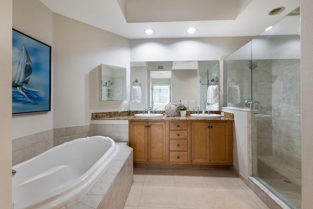 8500 Amberjack Cir Unit 102, Englewood, FL 34224 - full bathroom with a shower stall, tile patterned flooring, double vanity, a sink, and a bath