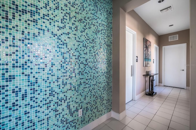 8500 Amberjack Cir Unit 102, Englewood, FL 34224 - hallway with baseboards, visible vents, and light tile patterned floors