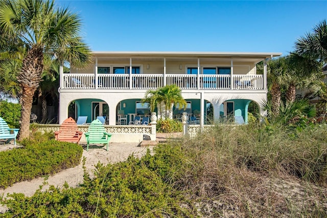 rear view of property with a balcony