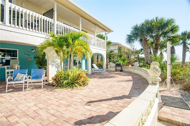 view of patio featuring a balcony