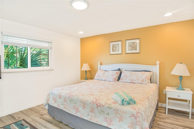 bedroom with baseboards, recessed lighting, and wood finished floors