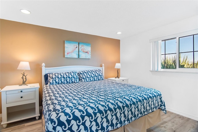 bedroom featuring baseboards, recessed lighting, and wood finished floors