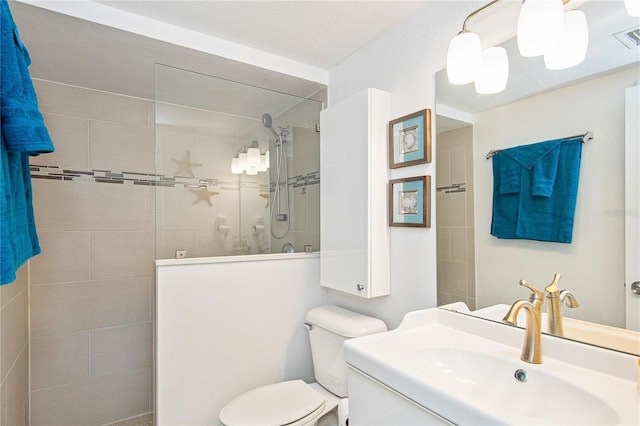 bathroom featuring vanity, walk in shower, and toilet