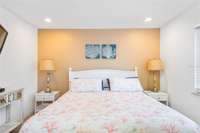 bedroom featuring baseboards and recessed lighting