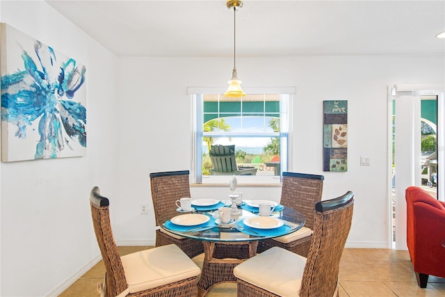 dining space with baseboards and light tile patterned floors