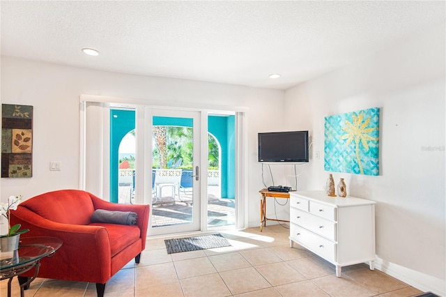 living room featuring recessed lighting, baseboards, and light tile patterned floors