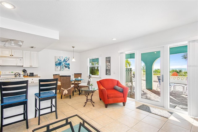 living area featuring light tile patterned floors, recessed lighting, and visible vents