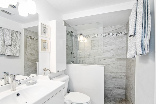 full bathroom with visible vents, a sink, walk in shower, and toilet