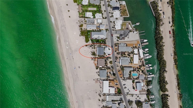 aerial view with a water view and a view of the beach