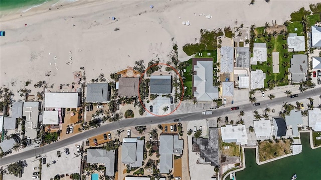 aerial view featuring a view of the beach and a water view