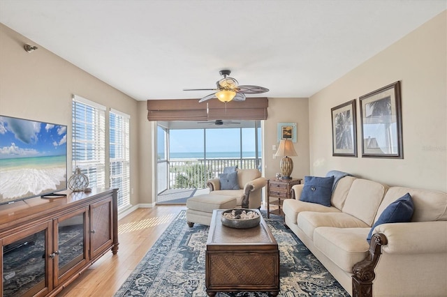 7470 Palm Island Dr Unit 2813, Placida, FL 33946 - living area with a wealth of natural light, light wood finished floors, baseboards, and ceiling fan