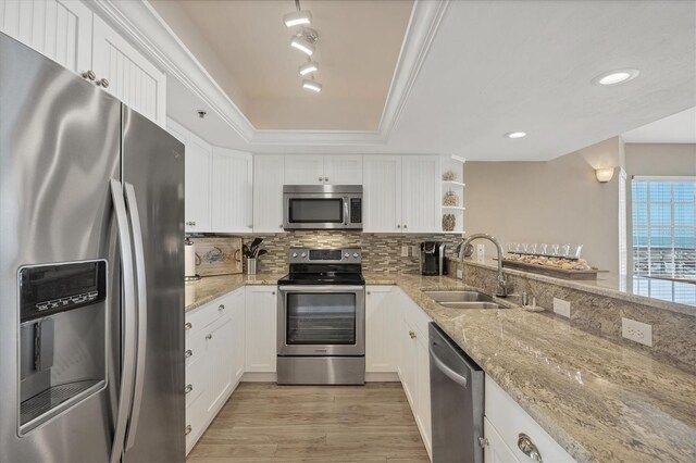 7470 Palm Island Dr Unit 2813, Placida, FL 33946 - kitchen featuring open shelves, a sink, stainless steel appliances, light wood-style flooring, and white cabinets