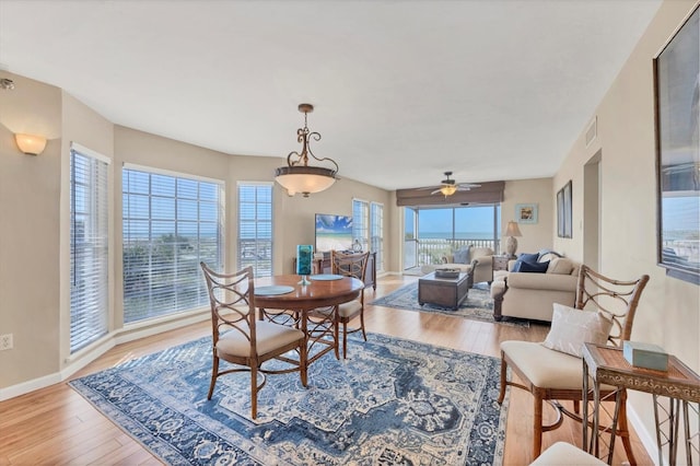 7470 Palm Island Dr Unit 2813, Placida, FL 33946 - dining space with wood finished floors, visible vents, a ceiling fan, and baseboards