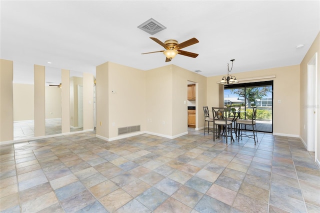 39 Bunker Pl, Rotonda West, FL 33947 - dining area featuring ceiling fan with notable chandelier, baseboards, visible vents, and stone finish flooring