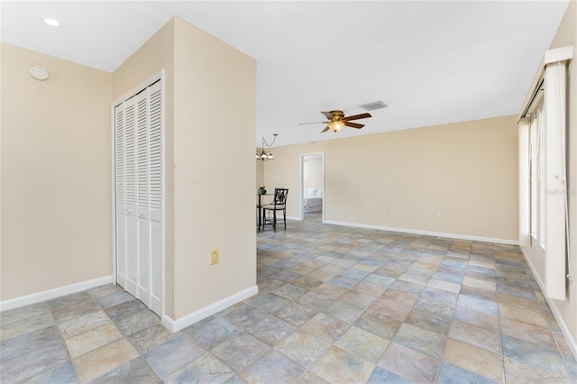 39 Bunker Pl, Rotonda West, FL 33947 - spare room featuring a ceiling fan, baseboards, stone tile floors, and visible vents